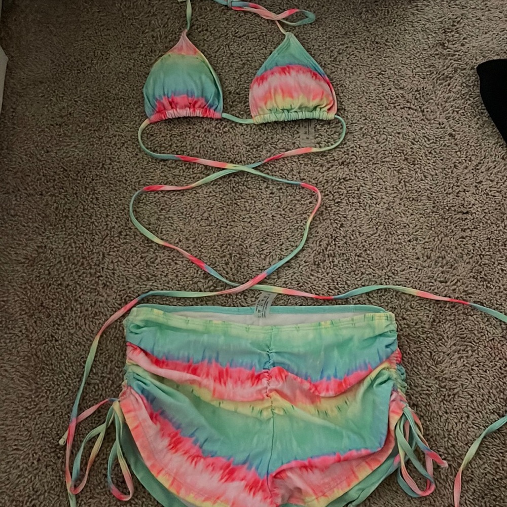 cross bathing suit top and swim shorts